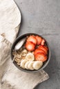Eating healthy breakfast bowl. Muesli and fresh fruits in ceramic bowl. Clean eating, dieting, detox, vegetarian food concept.
