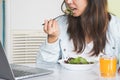 Eating healthy breakfast concept. woman holding dish of salad with variety vegetables and glass of orange juice.