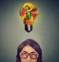 Eating healthy idea concept. woman looking up light bulb made of fruits above head Royalty Free Stock Photo