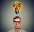 Eating healthy. Man looking up at fruit light bulb Royalty Free Stock Photo