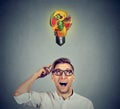 Eating healthy. Man looking up light bulb made of fruits Royalty Free Stock Photo