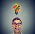 Eating healthy. Man looking up light bulb made of fruits Royalty Free Stock Photo