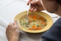 Eating home cooked soup witt carrots, noodels  and parsley Royalty Free Stock Photo