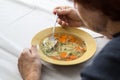 Eating home cooked soup witt carrots, noodels  and parsley Royalty Free Stock Photo