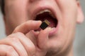 Putting micro SDHC memory card into the mouth - shallow focus Royalty Free Stock Photo