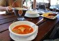 Eating outside - Hungarian fish soup halaszle and invisible eaters Royalty Free Stock Photo