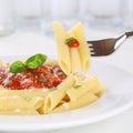 Eating pasta Rigate Napoli with tomato sauce with fork Royalty Free Stock Photo