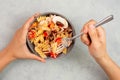 Eating a pasta salad with sliced mushroom, tomato, red pepper pieces and tuna, healthy food with vegetables, fresh organic Royalty Free Stock Photo