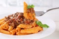 Eating Penne Rigate Bolognese or Bolognaise sauce noodles pasta