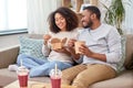 Happy couple with takeaway food and drinks at home Royalty Free Stock Photo