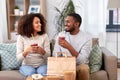 Happy couple with takeaway food and drinks at home Royalty Free Stock Photo