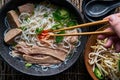 Eating pho with brisket and sriracha sauce Royalty Free Stock Photo