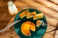 eating piece cheese cake with matcha cakes and bottle of milk at background in a sunny morning horizontal composition Royalty Free Stock Photo