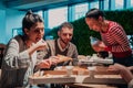 Eating pizza with diverse colleagues in the office, happy multi-ethnic employees having fun together during lunch Royalty Free Stock Photo