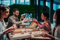 Eating pizza with diverse colleagues in the office, happy multi-ethnic employees having fun together during lunch Royalty Free Stock Photo