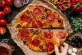 Eating pizza, top view. Hand taking slice of hot delicious pizza. Pizza ingredients on the wooden table Royalty Free Stock Photo