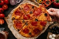 Eating Pizza, Top View. Hand Taking Slice Of Hot Delicious Pizza, Selective Focus. Pizza Ingredients On The Wooden Table