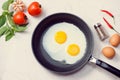 Eating in the process, fried eggs in a frying pan for breakfast Royalty Free Stock Photo