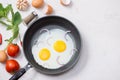 Eating in the process, fried eggs in a frying pan for breakfast Royalty Free Stock Photo