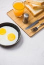 Eating in the process, fried eggs in a frying pan, toast and or Royalty Free Stock Photo