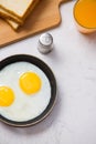 Eating in the process, fried eggs in a frying pan, toast and or Royalty Free Stock Photo