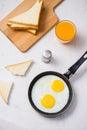 Eating in the process, fried eggs in a frying pan, toast and or Royalty Free Stock Photo