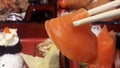 Eating raw fish in a Japanese restaurant