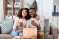 Happy couple with takeaway food and drinks at home Royalty Free Stock Photo