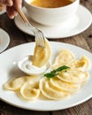 Eating russian dumplings vareniki with sour cream