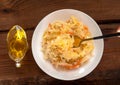 Sauerkraut on white plate wooden table. Pickled cabbage carrot Fermented by lactic acid bacteria vegetables sour flavor