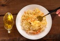 Sauerkraut on white plate wooden table. Pickled cabbage carrot Fermented by lactic acid bacteria vegetables sour flavor