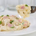Eating Spaghetti Carbonara noodles pasta meal on a plate with fork Royalty Free Stock Photo