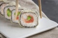 Eating Sushi with chopsticks.Closeup Sushi roll japanese food in restaurant Royalty Free Stock Photo