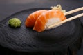 Eating sushi. Delicious Japanese cuisine, nigiri sushi with salm Royalty Free Stock Photo