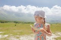 Eating sweet melon slice little girl enjoying Alpine view Royalty Free Stock Photo