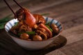 Eating Taiwanese food pork knuckle in a bowl with chopsticks