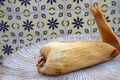 Eating Tamales in Oaxaca, Mexico. The tamal is masa filled with mole negro and chicken.