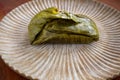 Eating Tamales in Oaxaca, Mexico. The tamale is masa filled with mole negro..