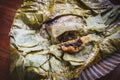 Eating Tamales in Oaxaca, Mexico. The tamale is masa filled with mole negro..