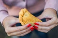 Eating traditional fried Spanish and Argentine empanadas at street food market.