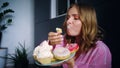 Eating woman enjoy cream cupcake. Woman tasting sweet cookies