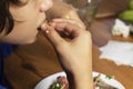 eats vegetable salad with a fork, mouth open Royalty Free Stock Photo