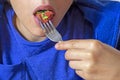 eats vegetable salad with a fork, mouth open wide. Royalty Free Stock Photo