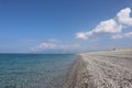 Beach on the coast of Calabria, Italy on a sunny summer day. Bright blue sea and white pebbles on a sunny summer day