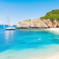 Beautiful beach with sailing boat yacht, Cala Macarelleta, Menorca island, Spain. Yachting, travel and active lifestyle concept Royalty Free Stock Photo