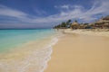 eautiful view of sandy Eagle Beach of Caribbean Sea with vacationing tourists on sun loungers under sun umbrellas.