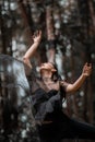 eautiful women with black ballet costumes flying in the air like reaching something in the sky Royalty Free Stock Photo