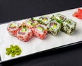 Ebiko black caviar adn red caviar sushi rolls - japanese food style. Served on a white plate over black background Royalty Free Stock Photo