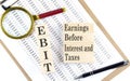 EBIT text on wooden block on chart background Royalty Free Stock Photo