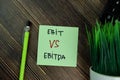 Ebit Vs Ebitda write on sticky notes isolated on Wooden Table
